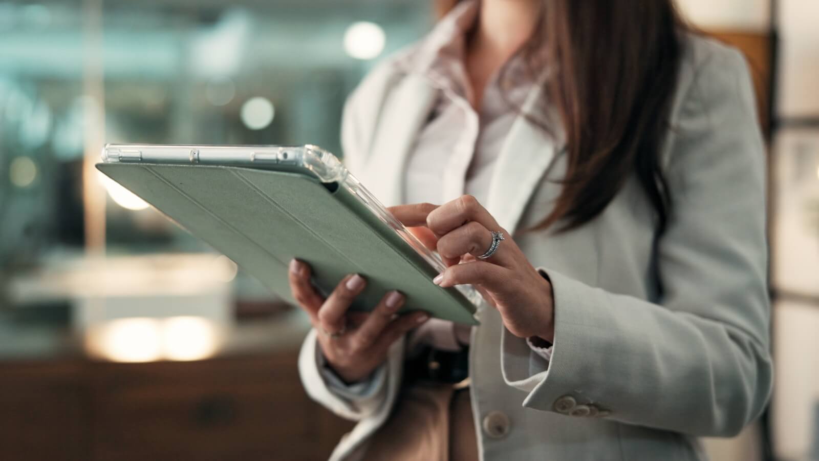 A woman reviews policies on a tablet.